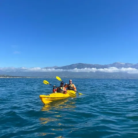 Kayakers on the water below the Kaikoura ranges