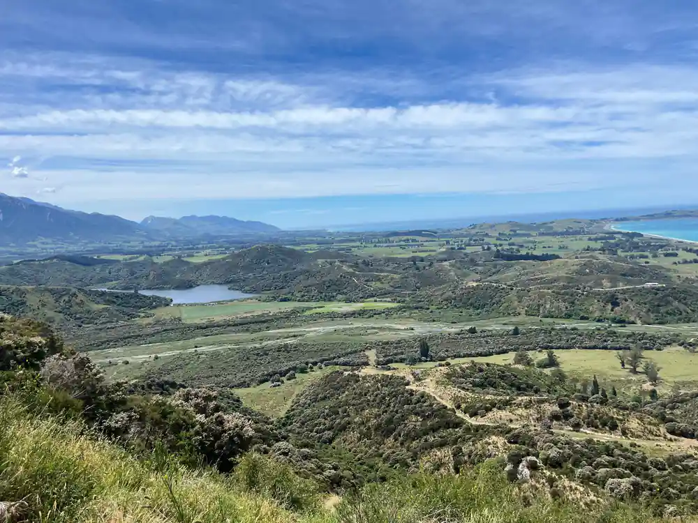 Farmland and the lagoon under a wide sky